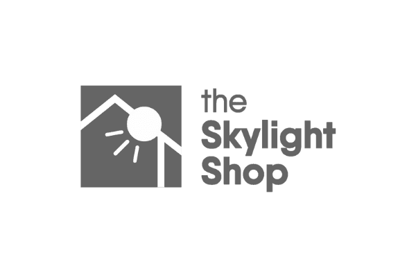 Logo with a stylized house roof and sun illustration, accompanied by the text "The Skylight Shop.